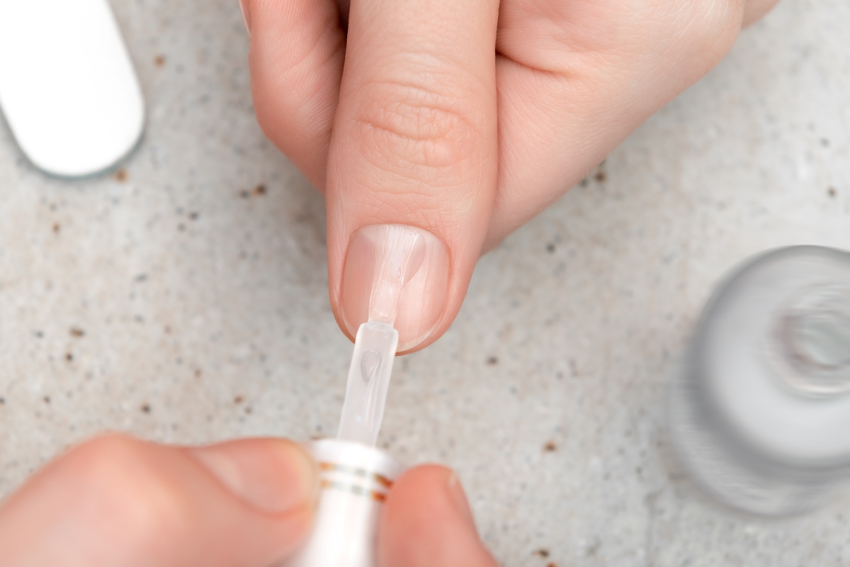 girl doing manicure by herself close up